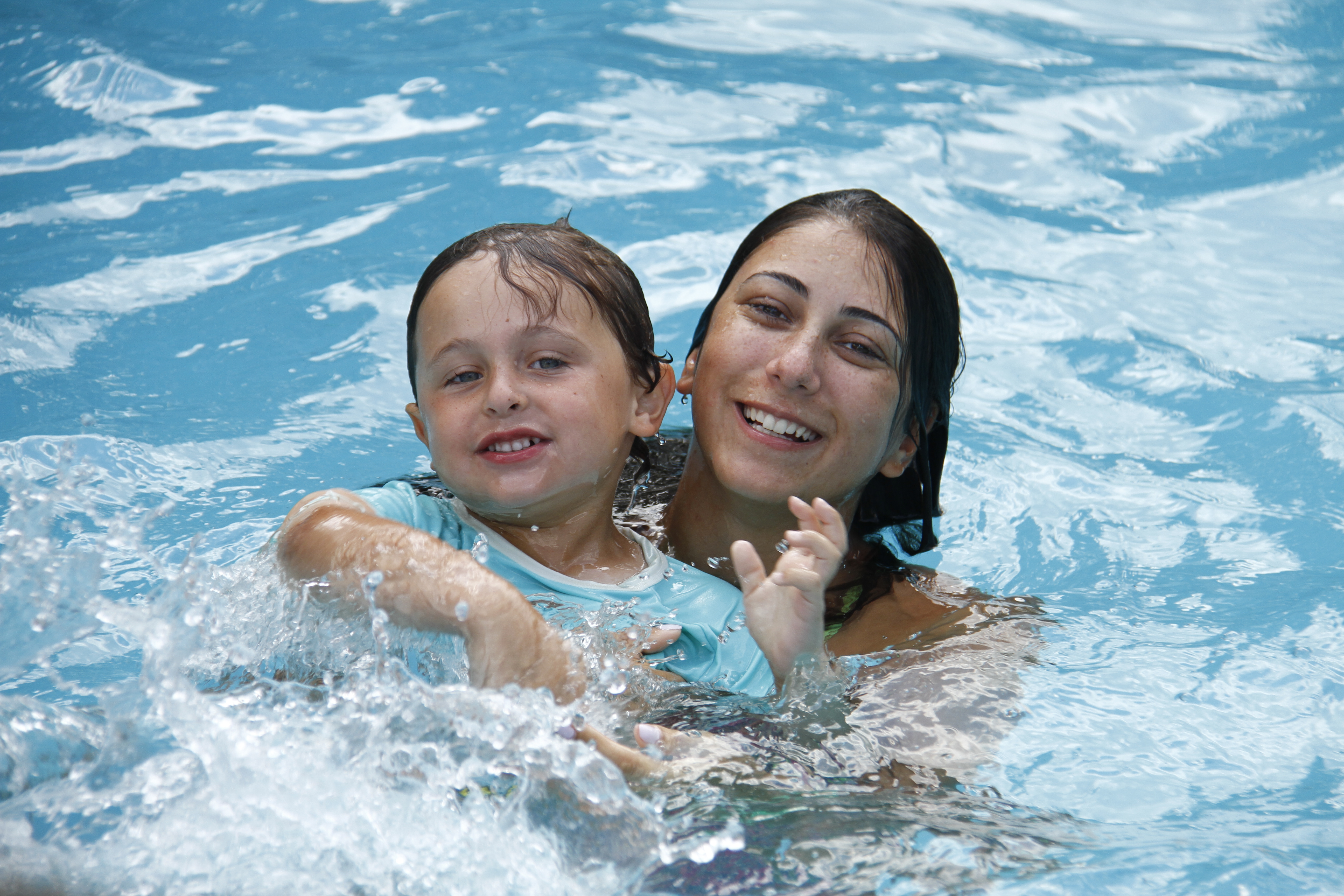 One of our highly trained swimming instructors helps a young camper learn how to swim.
